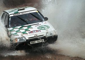 Pavel Sibera and Petr Gross in the factory Škoda Favorit 136L splashing through Rally Australia during the marque's championship-winning 1994 season in the FIA F2 World Rally Championship. 