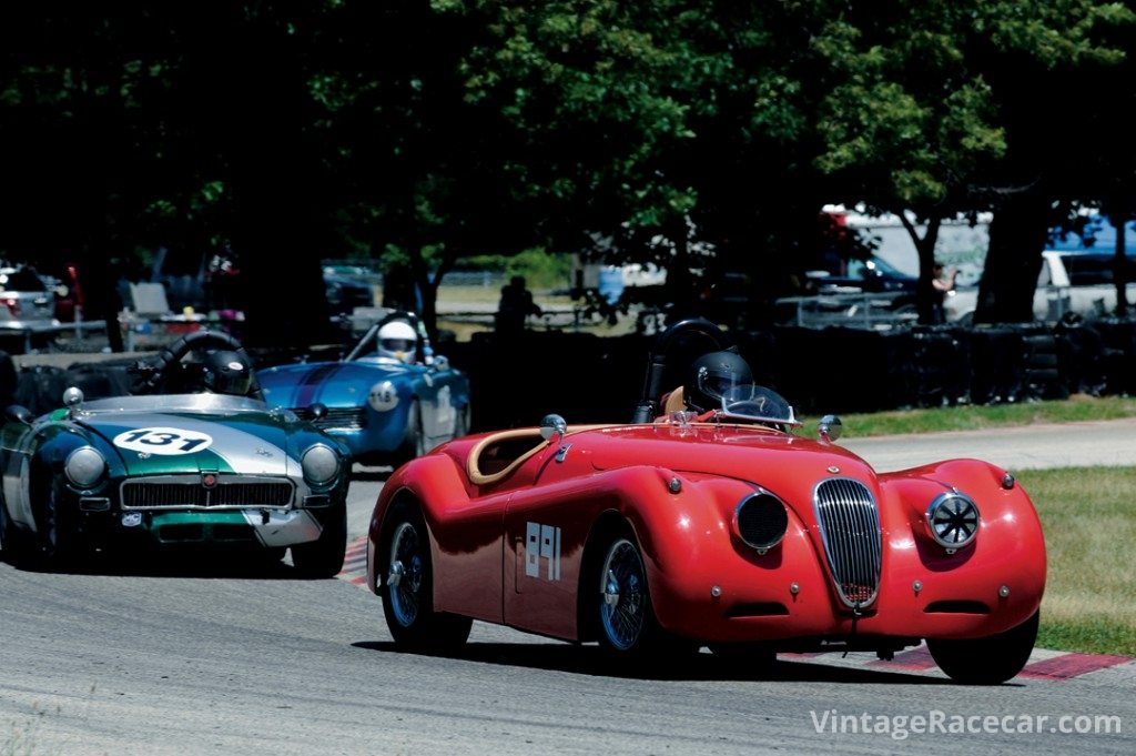 Charles Rydberg's Jaguar XK 120 leads Dave Bralich’s 1969 MGB through turn 4 during Sunday’s Feature race.<br /> Photo: Jim Hatfield