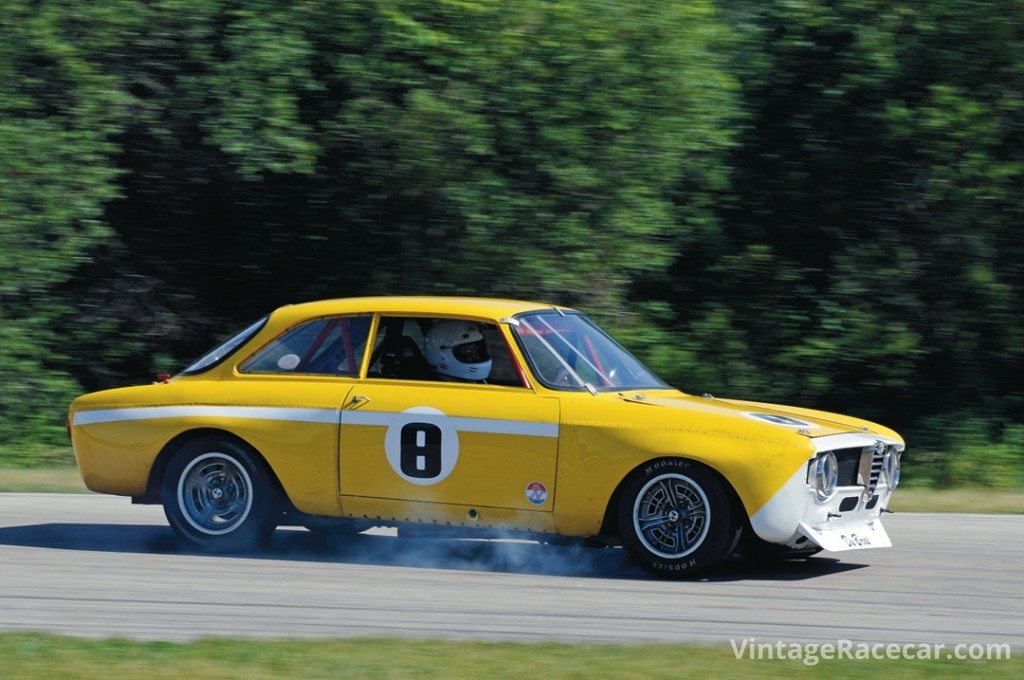 Locking a front wheel while braking his 1966 Alfa Romeo GTV into Turn 6 during Sunday’s Dad’s Day Scramble Handicap race is Erik Wood.<br /> Photo: Jim Hatfield