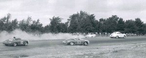 The Porsches of Howard Fowler (#63) and Buel Kinne (#112) take evasive action as another Speedster kicks up some dirt off-track, driver’s left, during the Schuyler Carrera race.