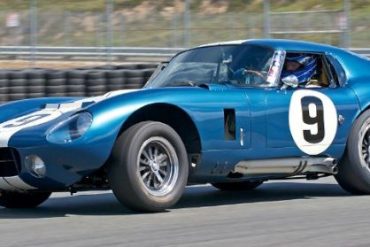 Rob Walton's 1965 Cobra Daytona Coupe accelerates out of turn Eleven.