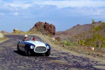 Michael Leventhal turns over the steering wheel of his 1953 Ferrari 340 MM Le Mans Spyder to Derek Hill. The car is the very one that Hill’s father first drove and raced in Europe.