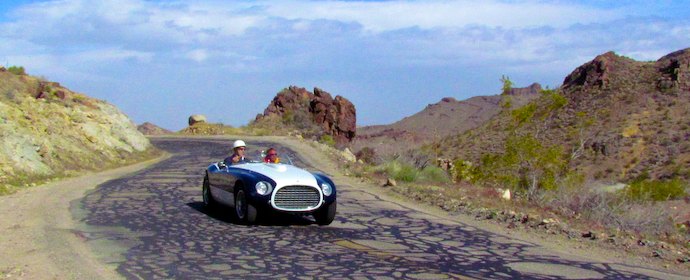 Michael Leventhal turns over the steering wheel of his 1953 Ferrari 340 MM Le Mans Spyder to Derek Hill. The car is the very one that Hill’s father first drove and raced in Europe.