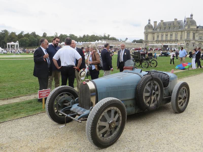 Bugatti Type 35B with the stunning Chateau de Chantilly in the background.