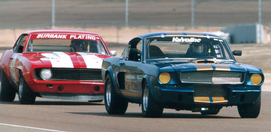 The Shelby GT350 of Jim Click leads the Camaro of Bob Scheer.