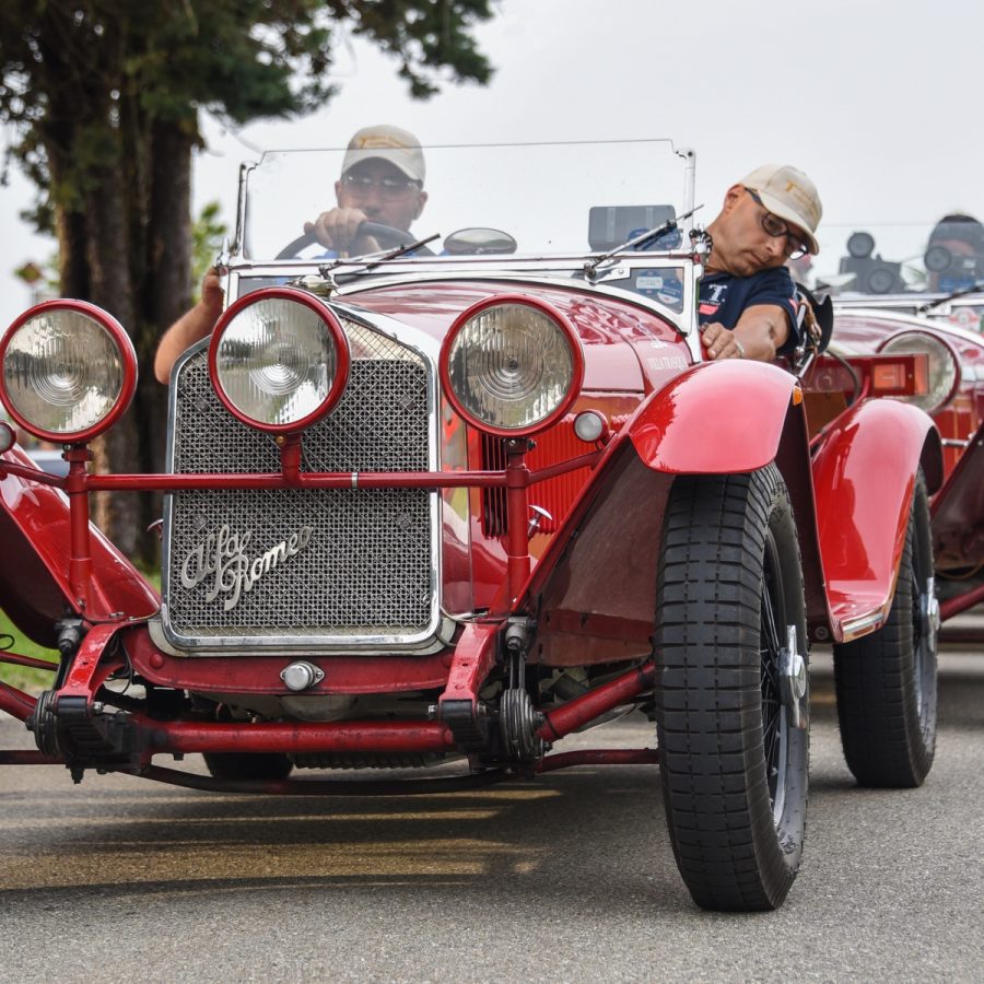 Line of red cars on road during 2021 Mille Miglia