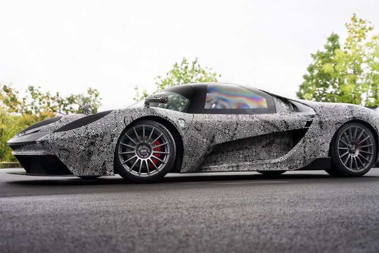 SCG 004 parked on road with trees in background