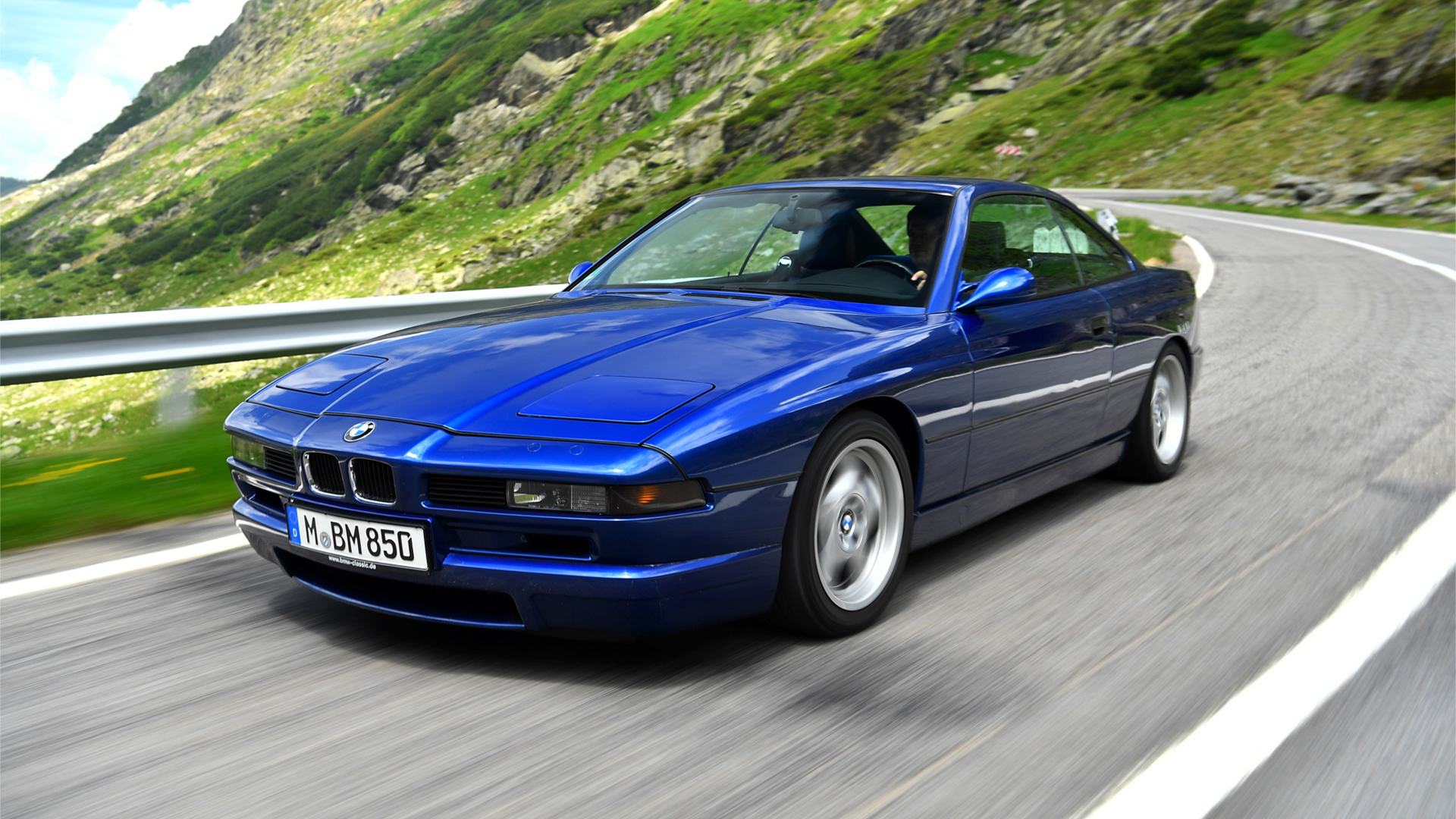 Blue BMW 850 CSi cruising