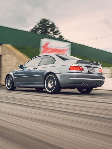 Silver BMW M3 E46 on a racetrack