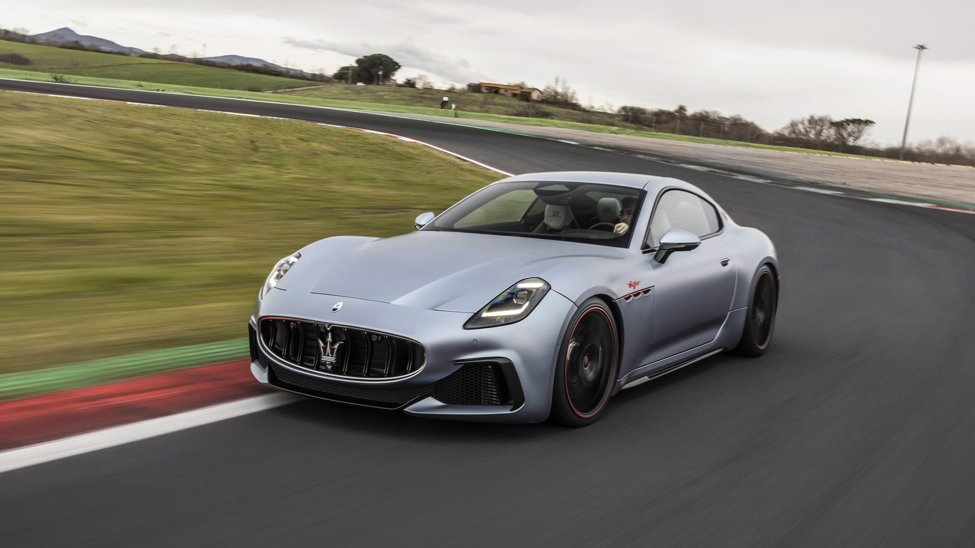 Photo of a silver Maserati Trofeo Primaserie 75 anniversary edition on a racetrack