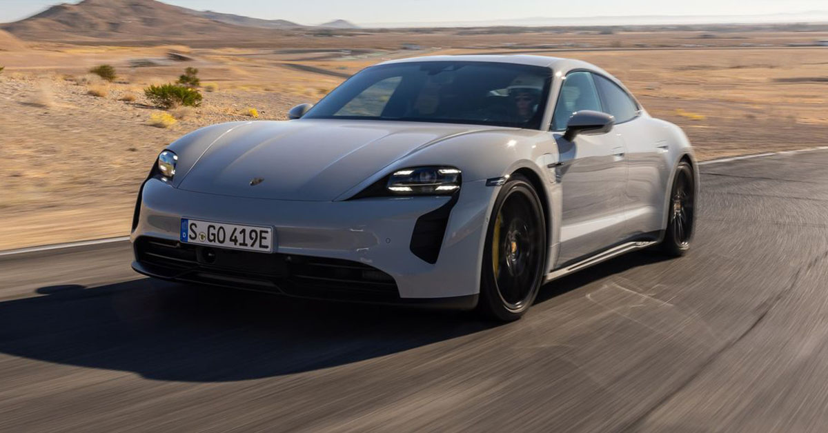 Photo of a Porsche Taycan cruising at desert road