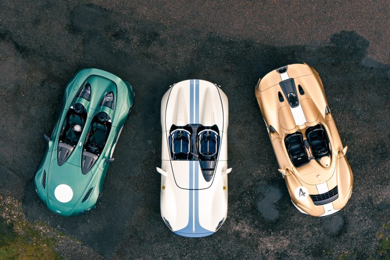 Aerial image showing a green Aston Martin V12 Speedster, white and blue Ferrari Monza SP2 and gold and white McLaren Elva.