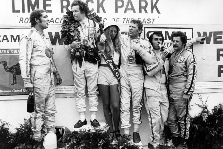 The winning 1973 Lime Rock Camel GT class drivers on the podium. L to R, Warren Agor, Peter Gregg, Ludwig Heimrath Jr. Dave Nichols and John Magee. Fast company indeed!